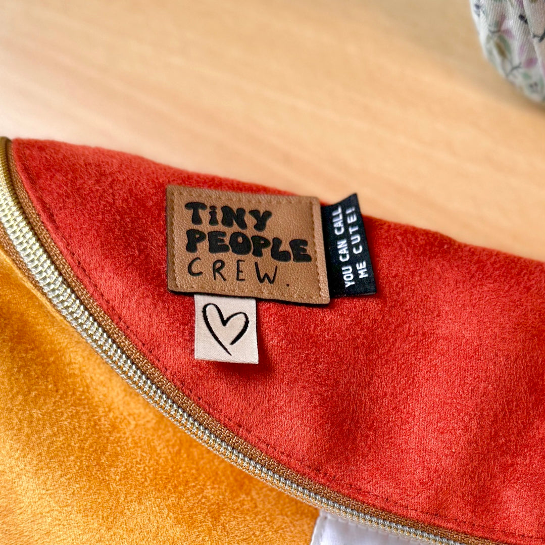 Faux leather label “Tiny People Crew”